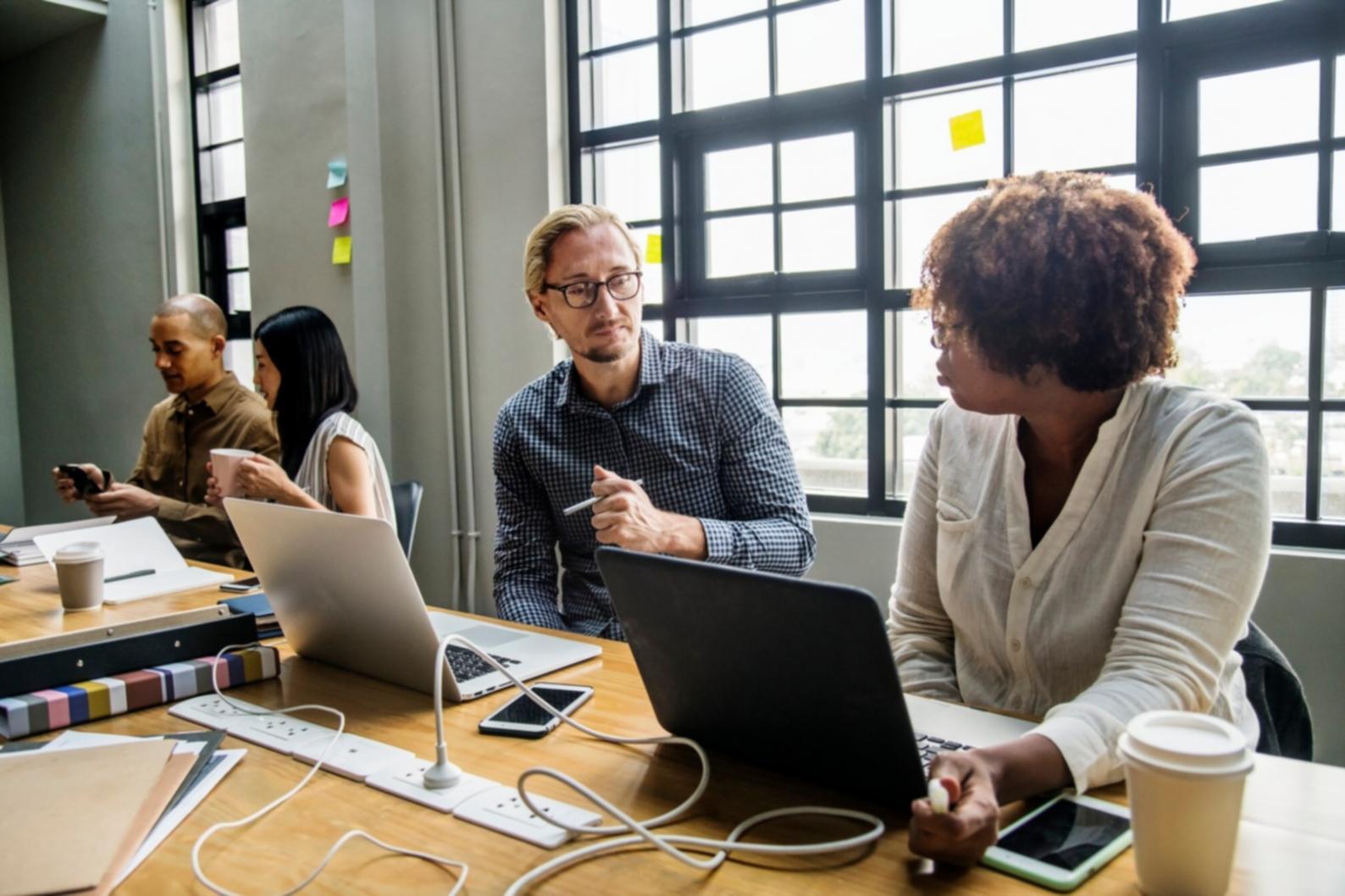 Budget compliance workshop session with financial documents and collaborative work environment